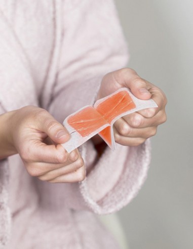 Ragazza che separa le due strisce depilatorie appena riscaldate
